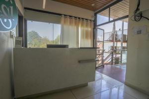 an office with a reception desk and a large window at Hotel Tulsi in Nadiād