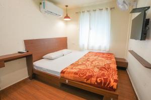 a bedroom with a bed in a room at Hotel Tulsi in Nadiād