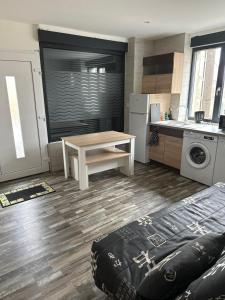 a kitchen with a table and a sink and a stove at T1 studio in Farschviller