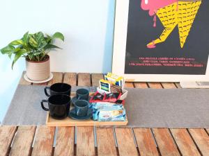 a tray of coffee mugs and a plant on a table at Banchi Centrale in Riomaggiore +24 photos