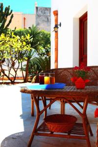 a wooden table with two drinks on a patio at B&B Sabir in San Vito lo Capo