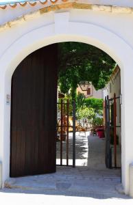 a wooden door leading to a room with a door open at B&B Sabir in San Vito lo Capo