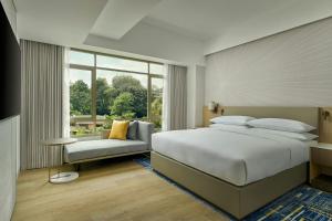 a bedroom with a large bed and a window at Petaling Jaya Marriott Hotel in Petaling Jaya +27 photos