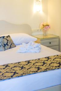 a bed with a white comforter on top of it at Polyxenia Suites in Rethymno