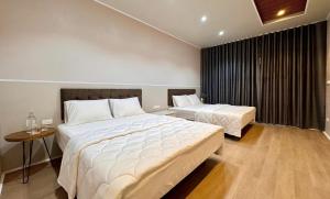a hotel room with two beds and a table at PALM Minh Chau Hotel-Only for Vietnamese in Quang Ninh