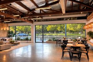 a living room with tables and chairs and a couch at Voltage Lodge Collie in Collie