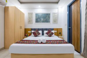 a bedroom with a bed with two slippers on it at Fortune Inn Sector - 104 By ASPL in Noida +49 photos