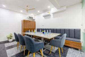 a dining room with a table and chairs at Fortune Inn Sector - 104 By ASPL in Noida