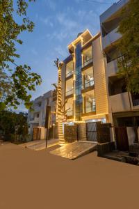 a building with a palm tree in front of it at Fortune Inn Sector - 104 By ASPL in Noida