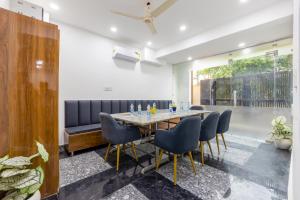 a dining room with a table and chairs at Fortune Inn Sector - 104 By ASPL in Noida
