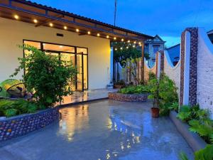 a patio of a house with lights and plants at PALM Minh Chau Hotel-Only for Vietnamese in Quang Ninh