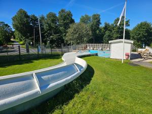 a water slide in a park with a playground at Trellebystrands Camping in Lysekil