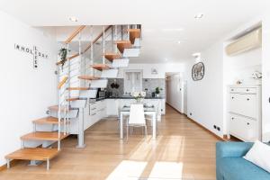 a kitchen and dining room with a spiral staircase in a living room at -Fronte Mare- Centro Storico in Varazze