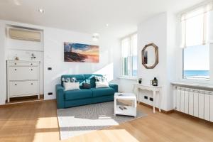 a living room with a blue couch and a mirror at -Fronte Mare- Centro Storico in Varazze