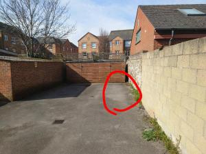 a red object is leaning against a brick wall at Basin Road 2 Bed House in Chichester