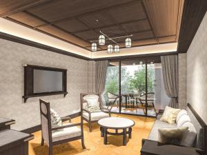 a living room with a tv and a table and chairs at Nara Hotel in Nara