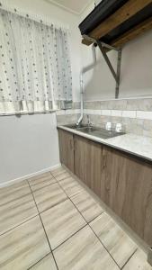 a kitchen with a sink and a counter at One Thirty Six in Gqeberha