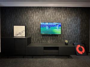a living room with a television on a wall at Royal 2 in Bucharest