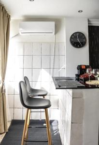 a chair sitting at a counter in a kitchen at Royal 2 in Bucharest