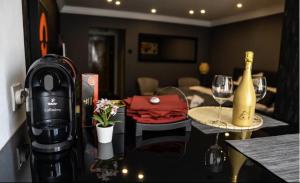a kitchen with a table with a bottle of wine and glasses at Royal 2 in Bucharest