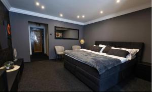 a bedroom with a large bed in a room at Royal 2 in Bucharest