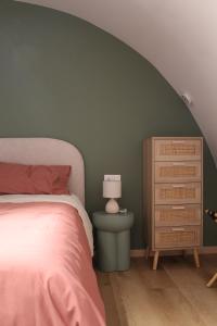 a bedroom with a bed and a dresser with a lamp at Le Casette della Murgia in Cassano delle Murge
