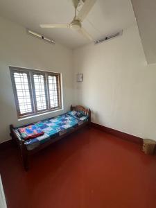 a room with a bed in the corner of a room at Hibisco Hideout in Meenangadi