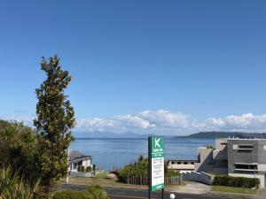 a street sign with a view of the water at Karaka Tree Motel in Taupo