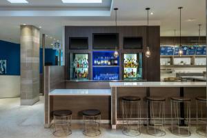 a bar with stools and a counter in a room at Courtyard Miami Beach South Beach in Miami Beach