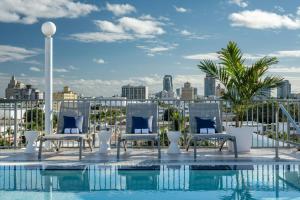 a pool with chairs and a view of the city at Courtyard Miami Beach South Beach in Miami Beach