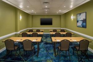 a conference room with tables and chairs and a tv at Courtyard Miami Beach South Beach in Miami Beach +24 photos