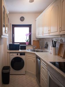 a kitchen with a sink and a dishwasher at EDGE of FOREST in Titisee-Neustadt +24 photos