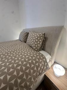 a bed with two pillows on it in a room at Panonski Mornar in Palić