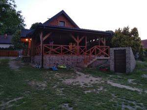 a house with a barn with a garage at Domek NAD RZEKA in Korczew