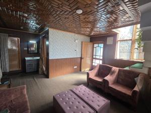 a living room with a couch and a table at Green House with kitchen in Srinagar