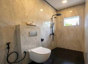 a bathroom with a toilet and a shower at Villa 55 Galle in Galle