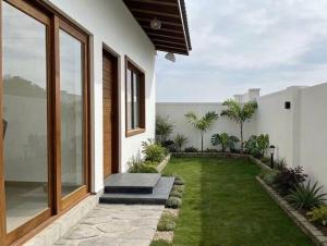 a backyard with a lawn and a house at Villa 55 Galle in Galle
