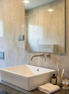 a bathroom with a white sink and a mirror at Villa 55 Galle in Galle +1 photo