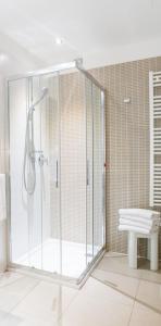 a shower stall in a bathroom with a bench at Hotel Centrale in Cernobbio +64 photos