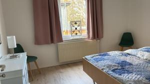 a bedroom with a bed and a window at Zollhaus 26 in Hohegeiß +51 photos