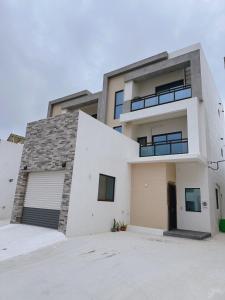 a large white house with a garage at Grass in the Wind B&B in Magong