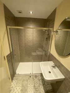 a bathroom with a shower and a sink and a toilet at The Tower Arms Hotel in Iver