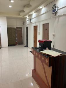 a lobby with a desk and a room with doors at Ghate rooms in Nagpur
