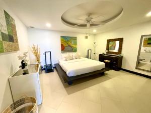 a bedroom with a bed and a ceiling at Kata Seaview Escape - 1BR Luxury Apartment 90sqm in Phuket +34 photos