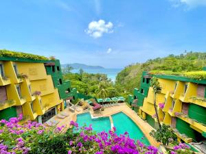 a view of the courtyard of a resort with flowers at Kata Seaview Escape - 1BR Luxury Apartment 90sqm in Phuket