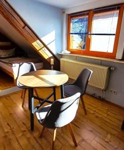 a room with a table and chairs and a bed at Sonnentor in Bad Wurzach