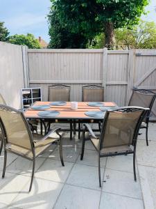 a wooden table with four chairs around it at Number 15 in Whitstable