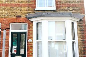 a brick building with two windows and a door at Number 15 in Whitstable