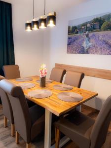 a dining room table with chairs and a painting at EDGE of FOREST in Titisee-Neustadt