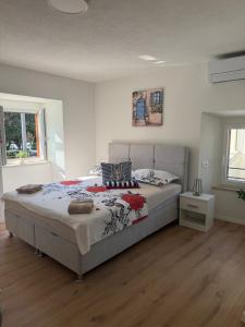 a bedroom with a large bed in a room at LUXURY Rooms Punat in Punat